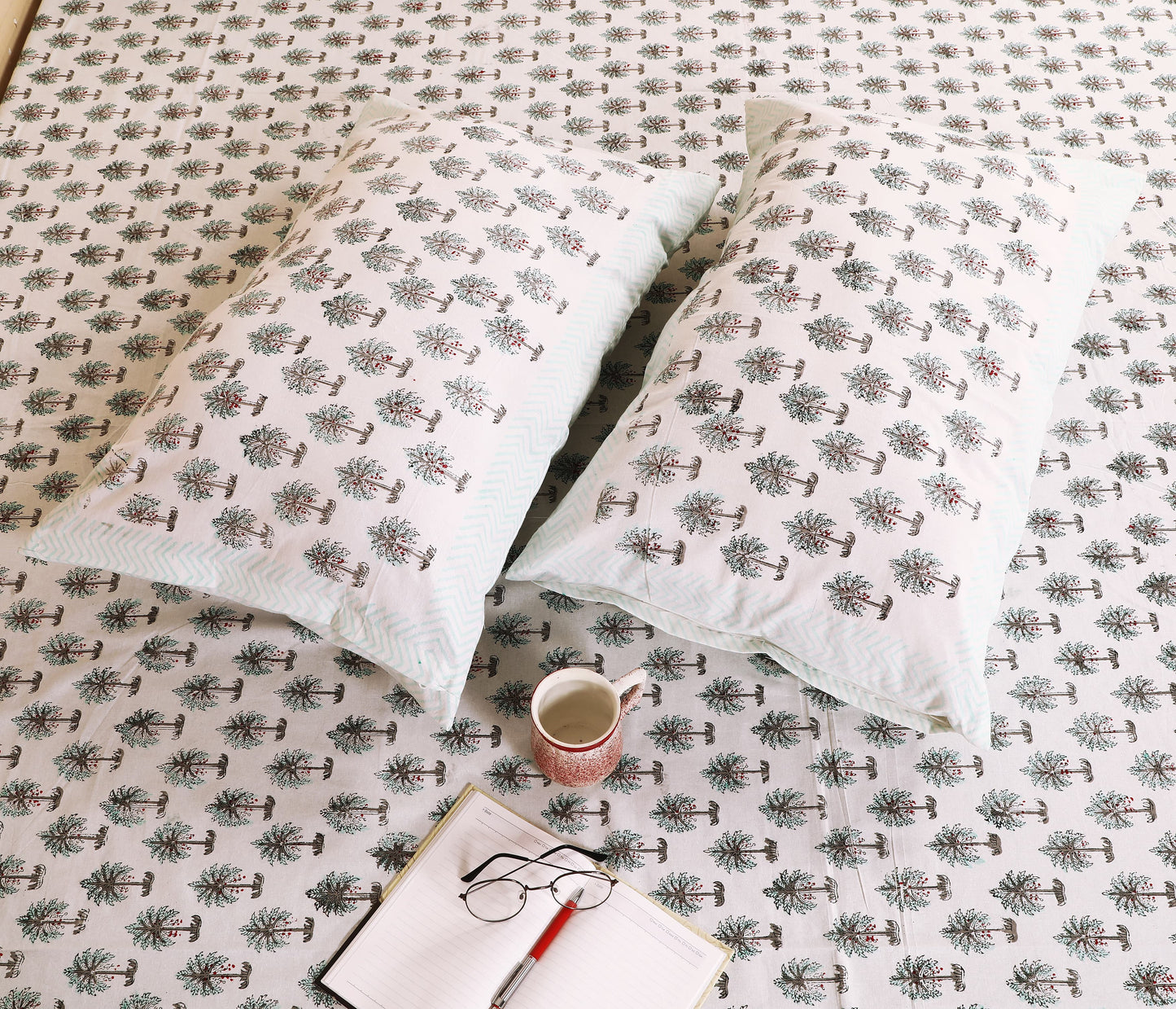 Highmour bedsheet featuring palm tree print fabric with matching pillow covers on a light background
