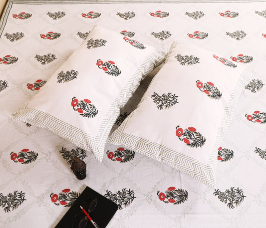 Highmour Bloomline collection bed linens featuring block print design on a white bedsheet with pillows