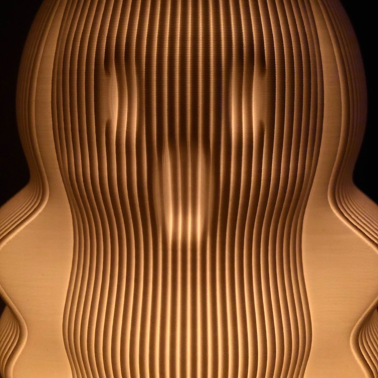 Unique modern decorative lamp featuring a wave-like design with warm glowing light