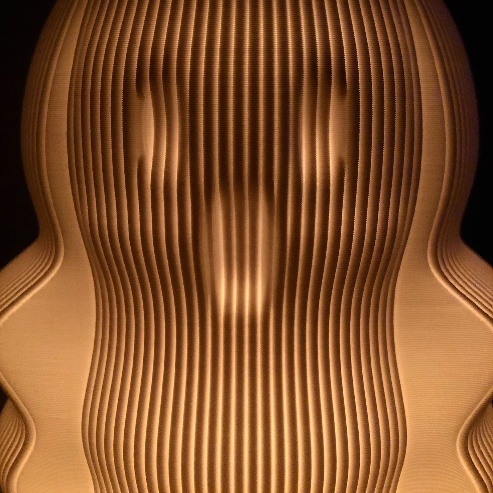 Unique modern decorative lamp featuring a wave-like design with warm glowing light