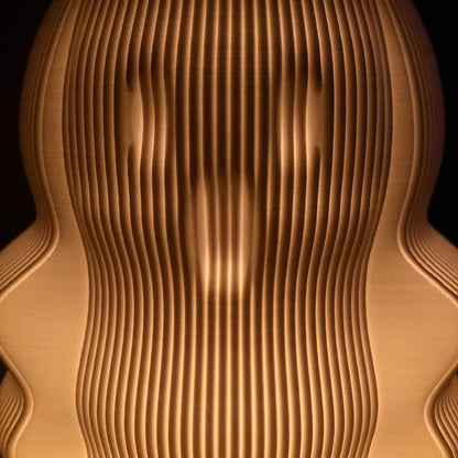 Unique modern decorative lamp featuring a wave-like design with warm glowing light