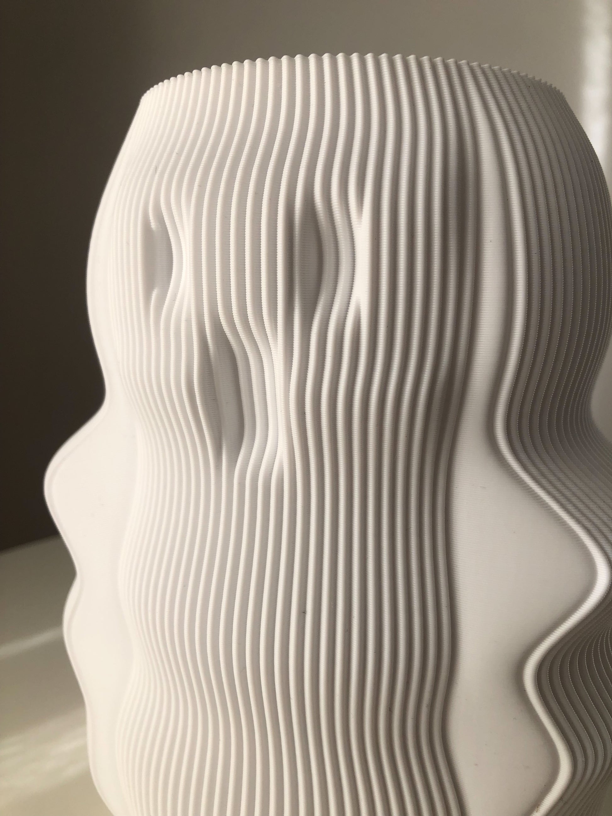 Modern decorative lamp with a unique wavy design and textured white finish for stylish home decor