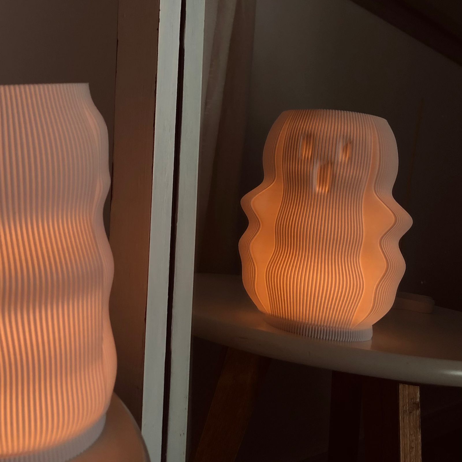 Unique modern decorative lamp with a wavy design, emitting a warm glow for stylish home decor