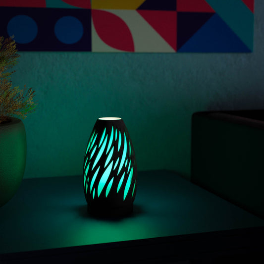 Highmour unique silhouette lamp with intricate design casting soft blue light on a minimalist table